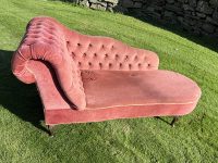A deep-buttoned small chaise longue
