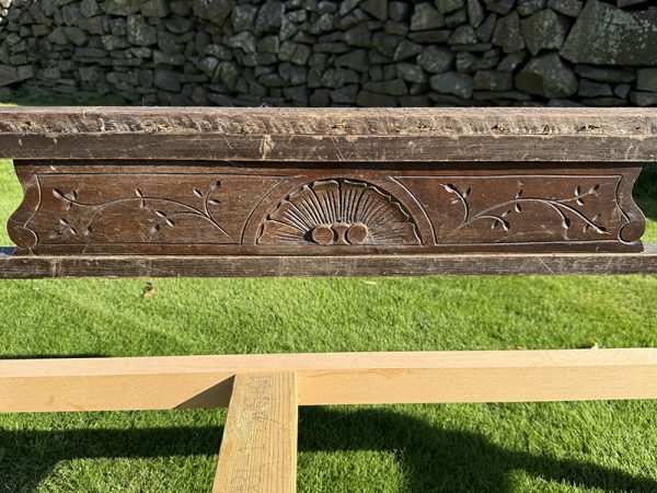 Detailed carvings on antique chaise longue frame arm