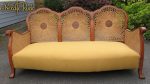 Traditionally upholstered Bergère Sofa. Gorgeous Bergère Sofa, with refurbished circular caning, traditional upholstery, and vibrant mustard woollen fabric.