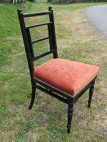 Black spindle chair. Black spindle chair upholstered in vibrant coral.