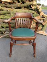 A pin-stuffed Captains Chair. Captains chair covered in a green faux leather.