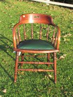 Captains chair. Captains chair covered in a green faux leather.