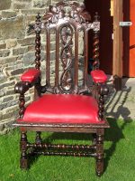 'Throne' with red leather upholstery. Ornately decorative 'Throne' with red leather upholstery.