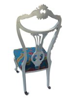 Ornate French painted bedroom chair. Ornate french-style bedroom chair, painted, on castors and covered in vibrant fabric from the 'Arley House' collection.