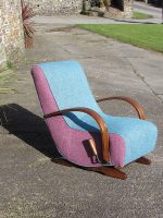 Teal Curved Rocking Chair A teal-coloured curved rocking chair with pink sides.