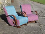 A non-identical pair of curved rocking chairs. A pair of curved rocking chairs with opposite colour schemes.
