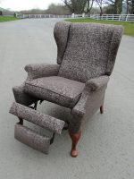 Grey masculine Parker Knoll chair. Masculine Parker Knoll Reclining chair covered in light-reflecting grey fabric.