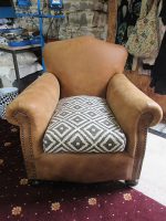 1940's Leather Club Chair 1940's Leather Club Chair covered in Tan leather with original sprung-filled feather cushions covered in a grey geometric woolly fabric, making it a very tactile chair.