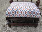 Twtty orangey/gold geometric footstool. Small footstool covered to match Prayer chair, in orangey/gold geometric fabric.
