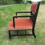 Upholstered spindle chair for Steve when he was at the furniture cave. Black elaborate upholstered spindle chair with orange upholstery
