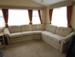 Static caravan upholstery. Large static caravan reupholstered in a beige patterned fabric.