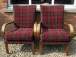 A pair of Bentwood Fireside Chairs A pair of Bentwood Fireside Chairs covered in a claret-coloured tartan fabric.
