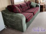 3-seater caravan sofa. 3-seater caravan sofa with deep red tartan cushions and contrasting sage-green carcass.