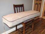 Church pew box cushion. Box cushion prepared for a church pew in a kitchen.