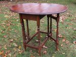 Refurbished oval gate-leg table. Small wooden refurbished oval gate-leg table.