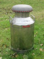 'Nestle' milk churn kitchen stool. 'Nestle' milk churn kitchen stool with matching red upholstery nails.