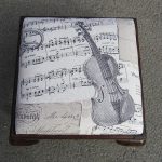 Violin footstool. A small low footstool given a classic 'violin & music' makeover.