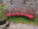 Set of 6 dining chairs covered in a red and rosy fabric. Set of 6 dining chairs covered in a red and rosy fabric.