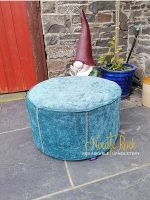 A round blue pouffe given a new lease of life. A round blue pouffe given a new lease of life.