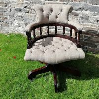 Deep buttoned captain's chair with grey fabric